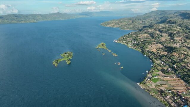Samosir island in sumatra with clear blue waters and lush landscapes, aerial view