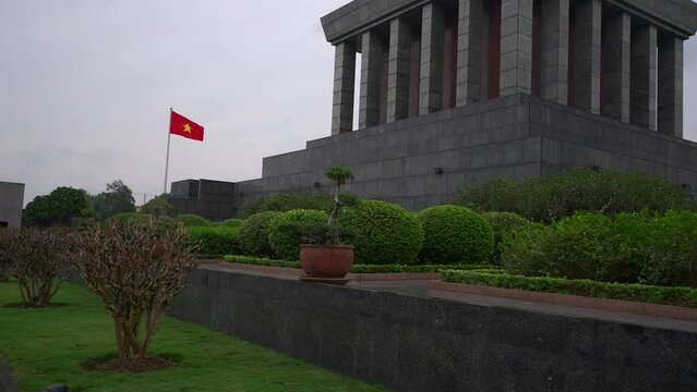 Slow motion shot of the Vietnamese flag blowing at Ho Chi Minh Mausoleum.