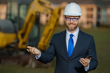 Civil engineer worker at a construction site. Mature engineer worker. Man in suit and hardhat...