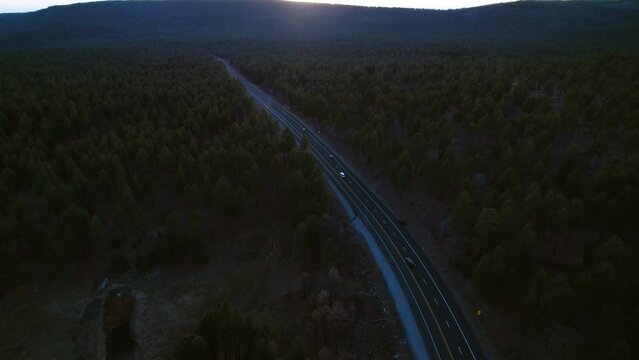 Drone Shot of Traffic on Freeway in Countryside of Arizona USA at Sunset, Pine Forest and Cars on Road
