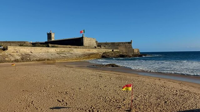 Carcavelos beach with the fortress or Fort of S&atilde;o Juli&atilde;o da Barra, the largest and most complete military defense complex in the Vauban style remaining in Portugal