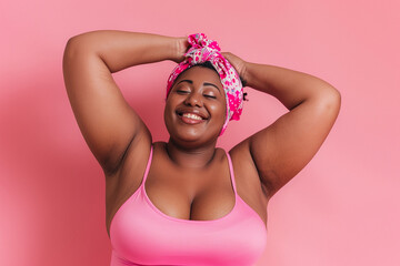 Portrait of a happy body positive African American woman isolated on pink background - obrazy, fototapety, plakaty