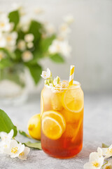 Lemon jasmine iced tea in a glass  on a gray background