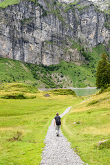 woman hiking in the Alps at the Oberblegisee lake in Glarus Switzerland