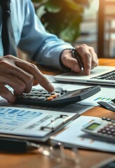 businessman working on desk office with using a calculator to calculate the numbers, finance accounting concept