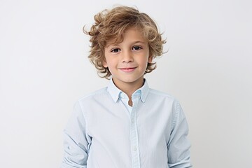 Portrait of cute little boy with blond curly hair and blue shirt