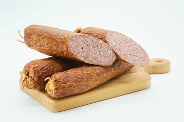 Meat dish sausage on a wooden board. The product is ready to use. White background.