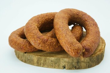 Meat dish sausage on a wooden board. The product is ready to use. White background.