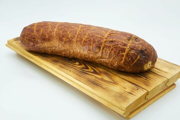 Meat dish ham or bacon on a wooden board. The product is ready to use. White background.