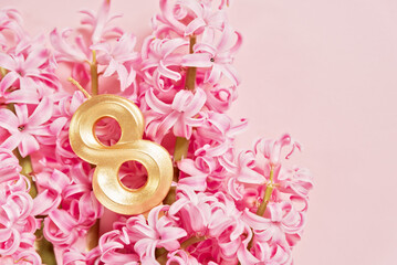 8 March greeting card. mother's day, International Women's Day congratulate Holiday background celebration concept. Pink hyacinth bouquet and 8 number on pink background.