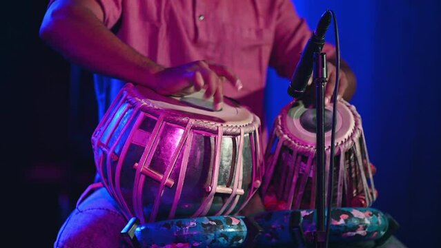 Musician seen playing tabla during event