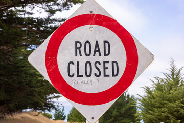 Road closed sign with sarcastic comment