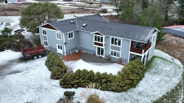 Two story house covered in snow on Whidbey Island.