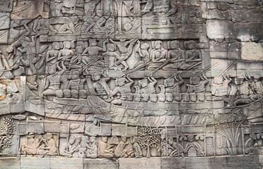 Fototapeta na wymiar Wall carving of Prasat Bayon Temple in famous landmark Angkor Wat complex, Siem Reap, Cambodia. Bas-relief depicting peasants going about daily routine