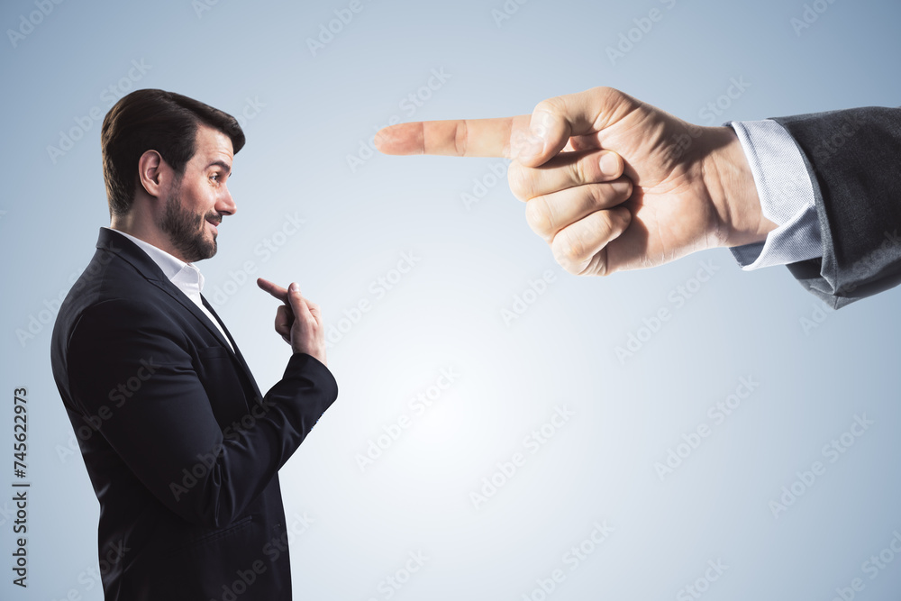 Poster abstract image of boss hand pointing at stressed businessman on light gray background. bad job decis