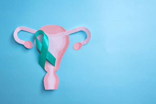 Teal Ribbon and Uterus Cutout. Ovarian cancer and Gynecological Disorders Concept.