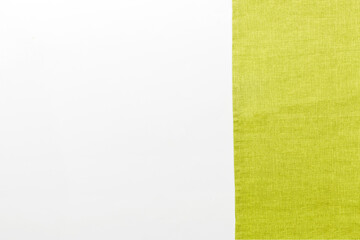 top view with green kitchen napkin isolated on table background. Folded cloth for mockup with copy space, Flat lay. Minimal style
