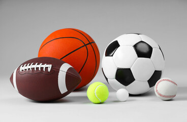 Many different sports balls on light gray background