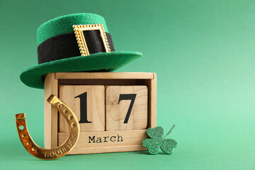 St. Patrick's day - 17th of March. Wooden block calendar, leprechaun hat, golden horseshoe and...