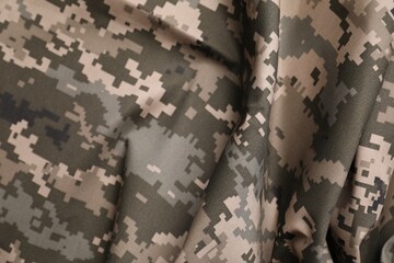 Texture of crumpled camouflage fabric as background, top view