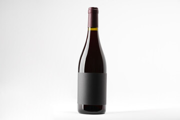 Bottle of tasty red wine on white background, space for text