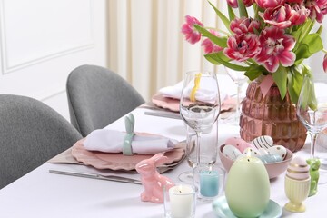 Festive table setting with beautiful flowers. Easter celebration