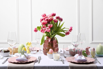 Festive table setting with beautiful flowers. Easter celebration