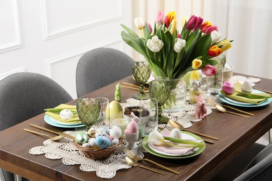 Festive table setting with beautiful flowers. Easter celebration