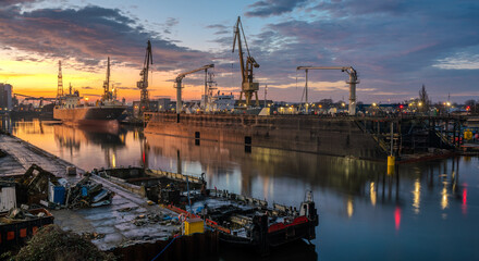 Ship repair at the ship repair yard during a spectacular sunrise - 745642549