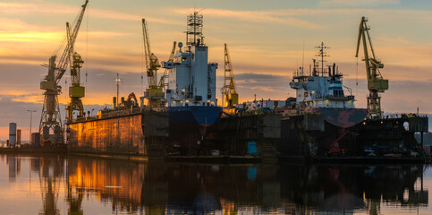 Ship repair at the ship repair yard during a spectacular sunrise - 745642589