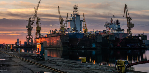 Ship repair at the ship repair yard during a spectacular sunrise - 745642717