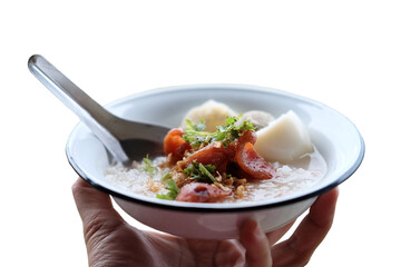 Woman hand holding rice porridge with pork and Fried Chinese sausage in white bowl