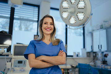 Portrait of ER doctor in hospital working in emergency room. Portrait of beautiful nurse in blue...