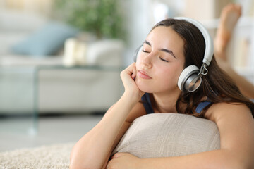 Relaxed woman wearing headphone listening chill music