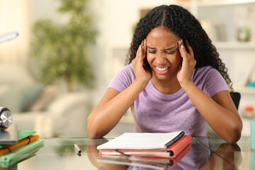 Stressed black student suffering head ache