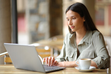 Woman in a coffee shop using laptop