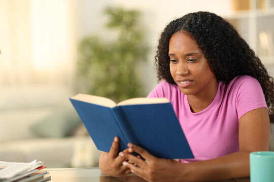Disgusted black woman reading a paper book