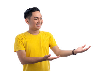 Portrait of happy handsome Asian man posing with both hands presenting something isolated on white background