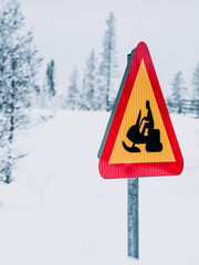 Yellow and Red Sign on Snow-Covered Road