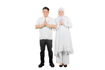 Muslim family of two adults showing greetings gesture