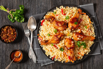 fried chicken drumsticks over rice pilaf, top view