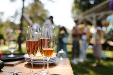 Close up shot of wine in glassed at summer garden party.