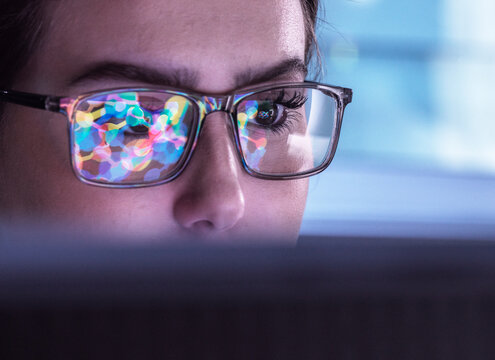 Scientist wearing eyeglasses and analyzing biochemical data on computer