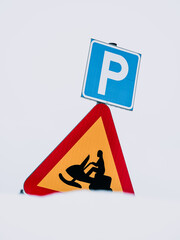 Swedish Road Sign Indicating Parking Place and Snowmobile Crossing Against a Snowy Background