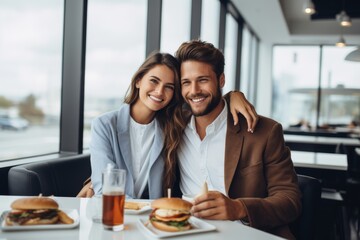 Couple enjoying burgers and drinks at a cafe, cheerful and connected