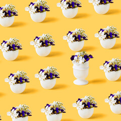 Easter pattern of white eggs with spring pear and primrose flowers on a orange background. Happy Easter concept. Greeting card.