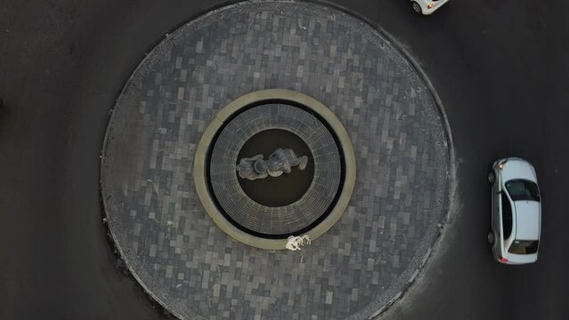 city ​​roundabout with sculpture and a senital shot