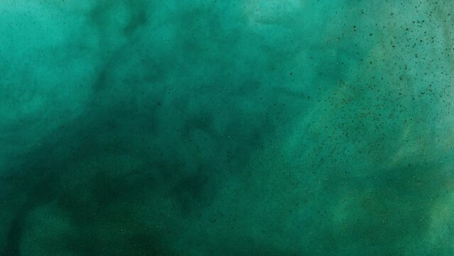Swirling Dark Ink With Particles In Green Water. Abstract Background 