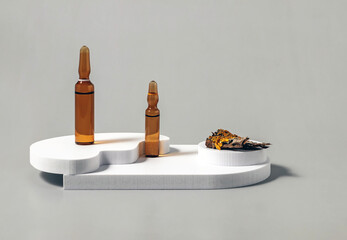medical ampoules and bark with lichens on a gray background.