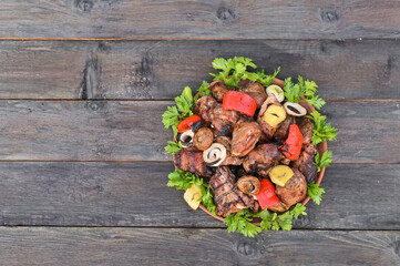 Barbecue with vegetables and herbs on a plate.
